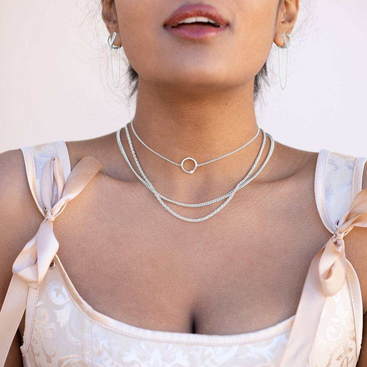 This rope chain necklace features carefully interwoven strands of metal, creating a unique pattern. Its sturdy construction ensures durability, while its light weight makes it comfortable to wear. Enjoy this beautiful accessory for years to come. Pair with the Flex Necklace or the Cyclical Choker to create the perfect layering look.