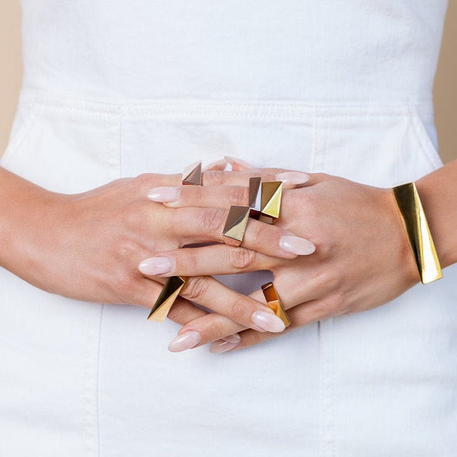 The initial design that the flex collection was built from, the Flex Double Finger Ring is a new must-have statement piece for any jewelry collection. Featuring a unique double-finger design, this attractive piece of jewelry is perfect for any style. The ring is made with high quality brass and 14K gold plated for durable wear. Add some flair and edge to any outfit with the Flex Double Finger Ring. Pair with the Flex Necklace to complete the look.