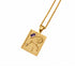 A gold pendant necklace featuring a zodiac design with a purple amethyst gemstone and a small clear stone, shown on a white background.