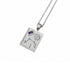 A silver-toned rectangular pendant necklace featuring an engraved zodiac symbol, stars, a sun motif, and a small purple gemstone, suspended from a matching silver chain against a white background.