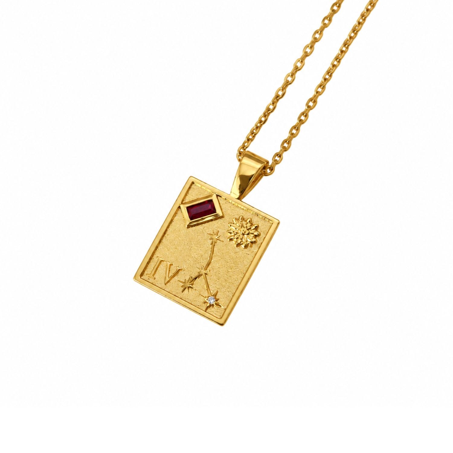 A gold square pendant necklace featuring an astrological symbol, a small red gemstone, and a tiny clear stone, suspended from a gold chain on a white background.