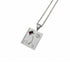 A silver-toned square pendant necklace featuring an astrological symbol, Roman numeral IV, a flower motif, and a small red rectangular gemstone, suspended from a matching chain on a white background.