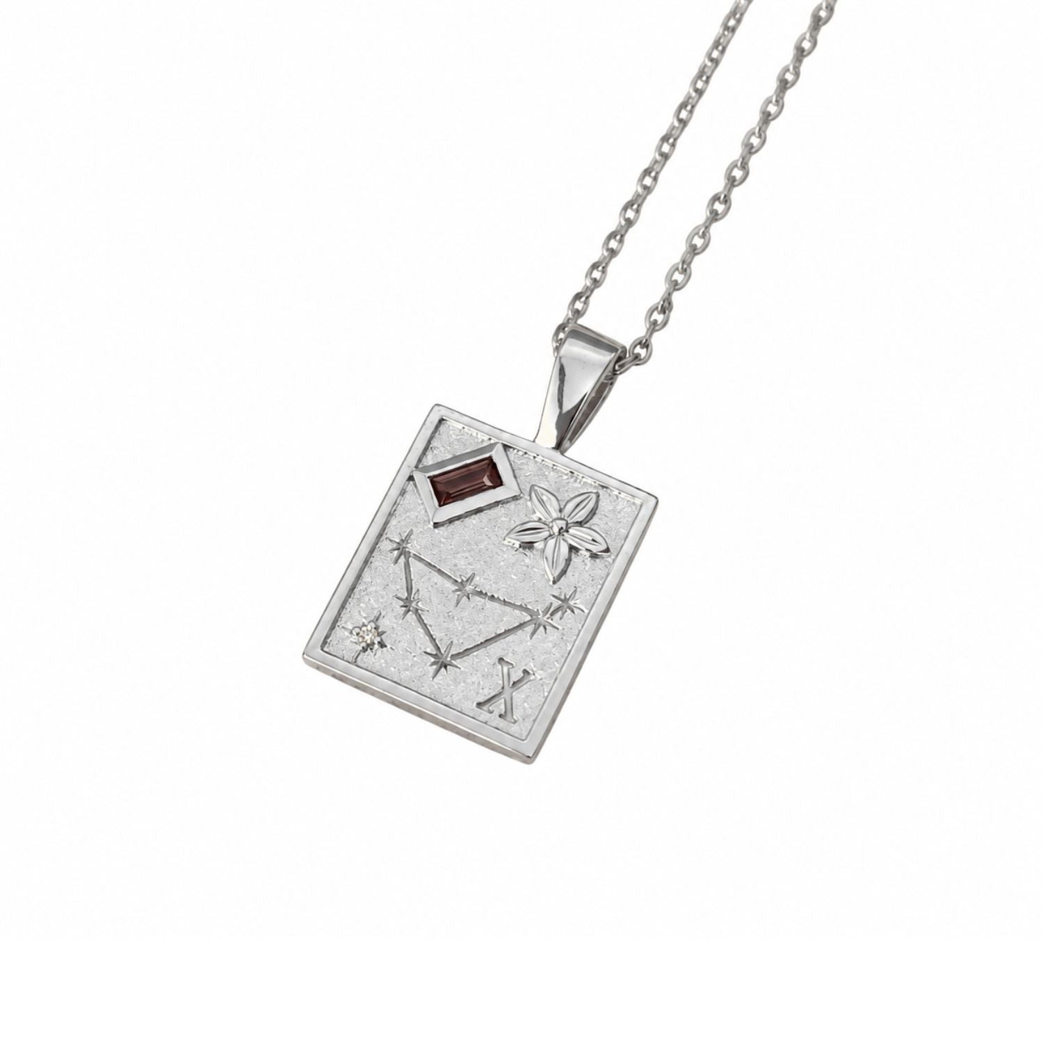 A silver pendant necklace featuring a rectangular pendant engraved with a constellation design, a flower motif, and a small dark red rectangular gemstone, shown on a white background.