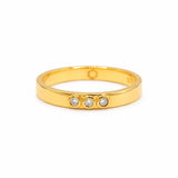 A gold vermeil ring featuring three lab grown diamonds bezel set, on a white background. 