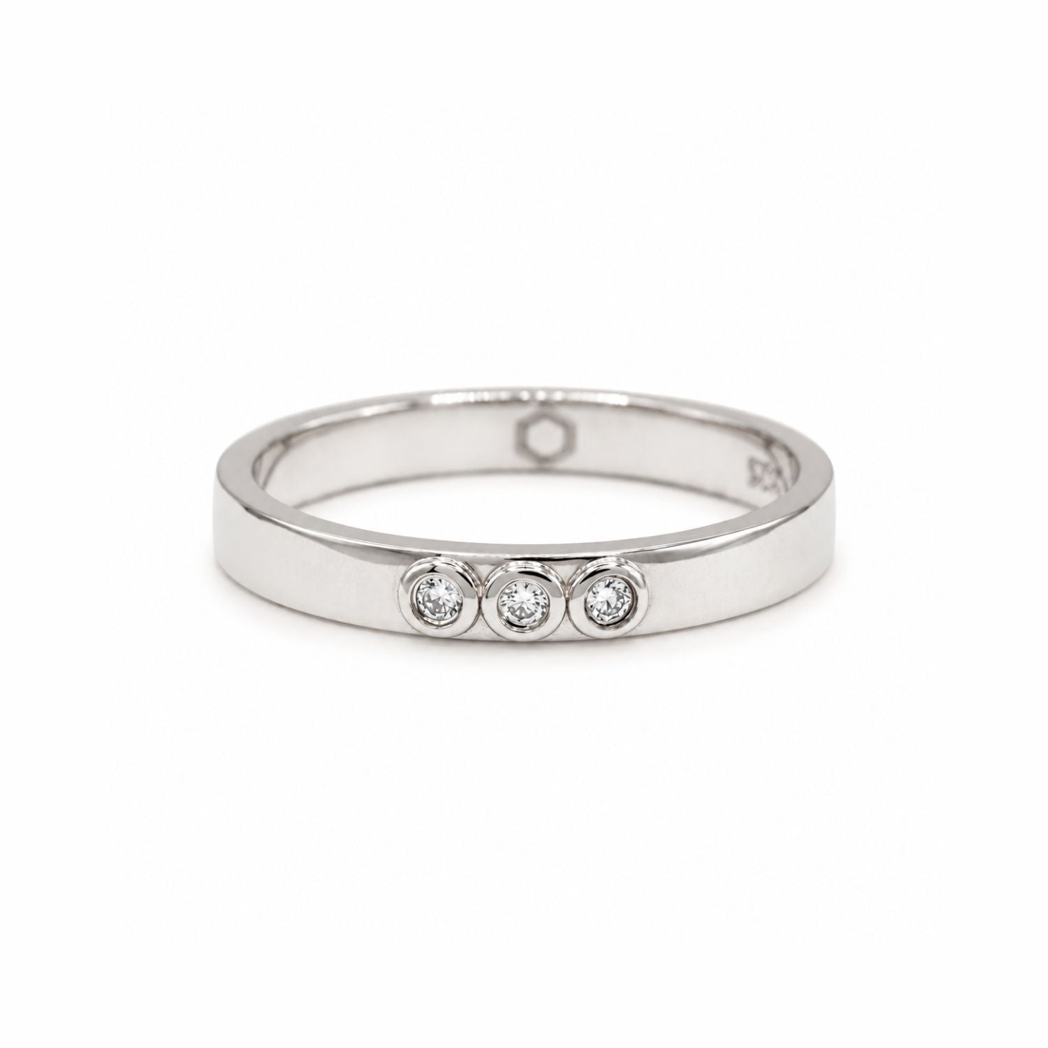 Slim silver ring with three lab-grown diamonds bezel set, displayed on a white background.