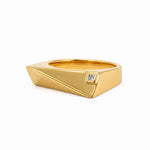 A gold geometric ring with a small square diamond accent, shown on a clean white background.
