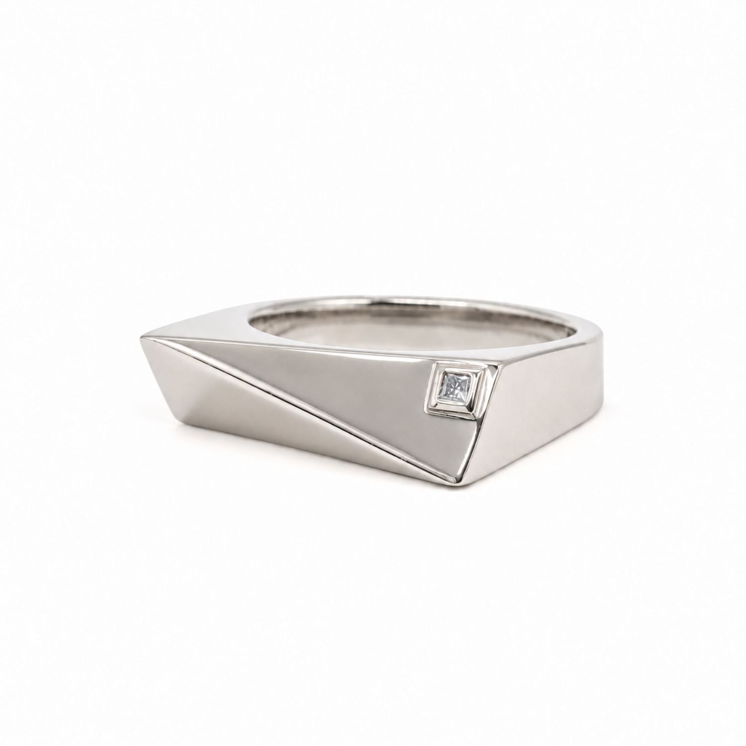 A silver geometric ring with a small square clear gemstone, shown on a plain white background.