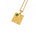 A gold pendant necklace featuring a square celestial map design with Roman numerals, a constellation, a wheat stalk, and a small green rectangular stone, shown on a white background.