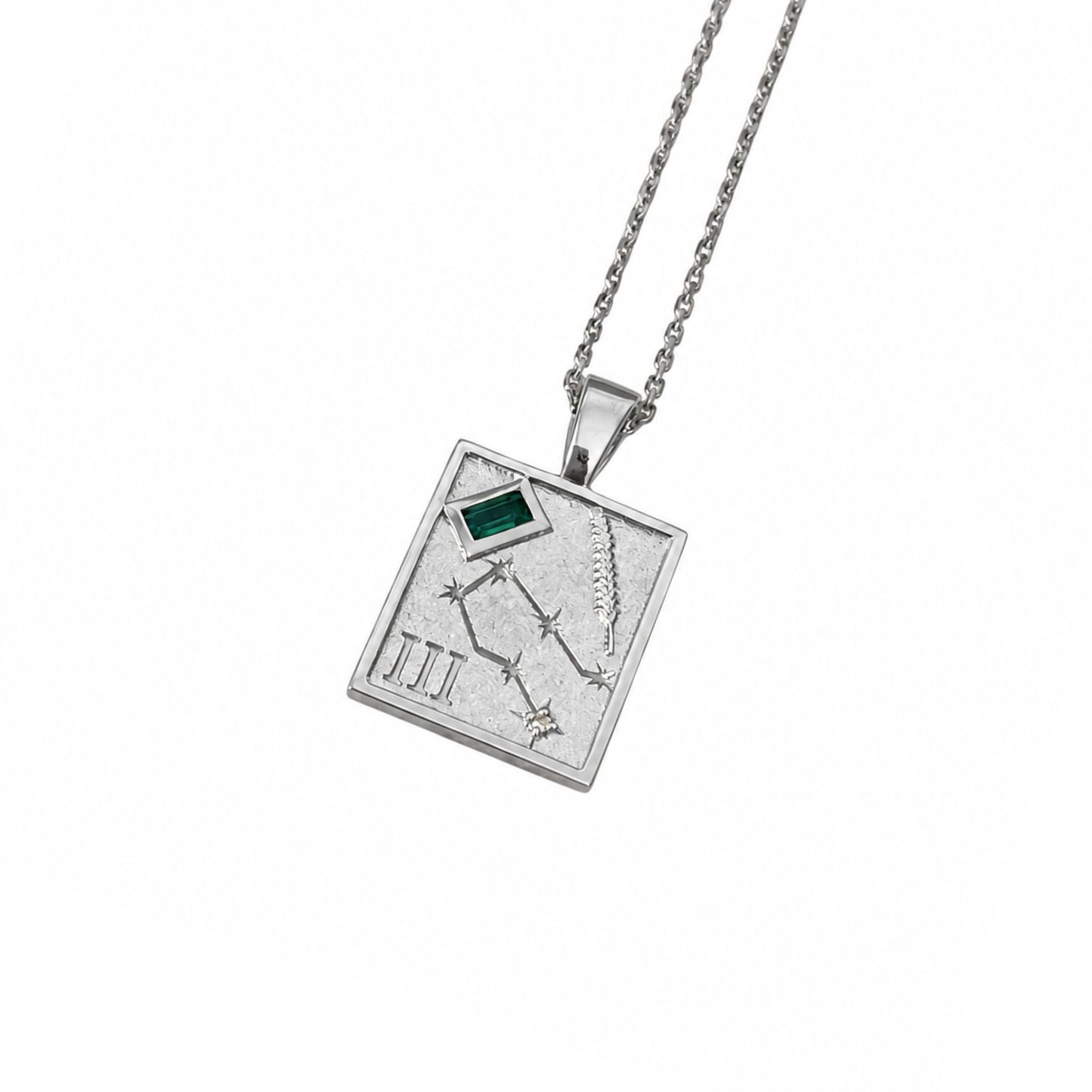 A silver-toned square pendant necklace featuring an engraved constellation design, Roman numeral III, and a small green rectangular inset, suspended from a matching silver chain against a plain white background.