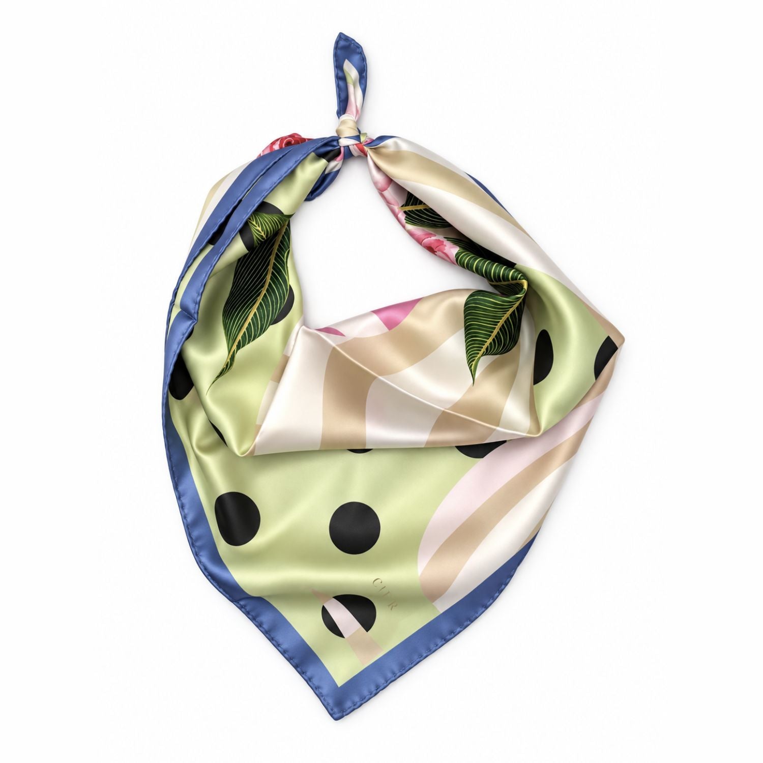 A square silk scarf with a tropical leaf print, black polka dots, and diagonal stripes in beige, pink, and blue, tied in a knot on a white background.