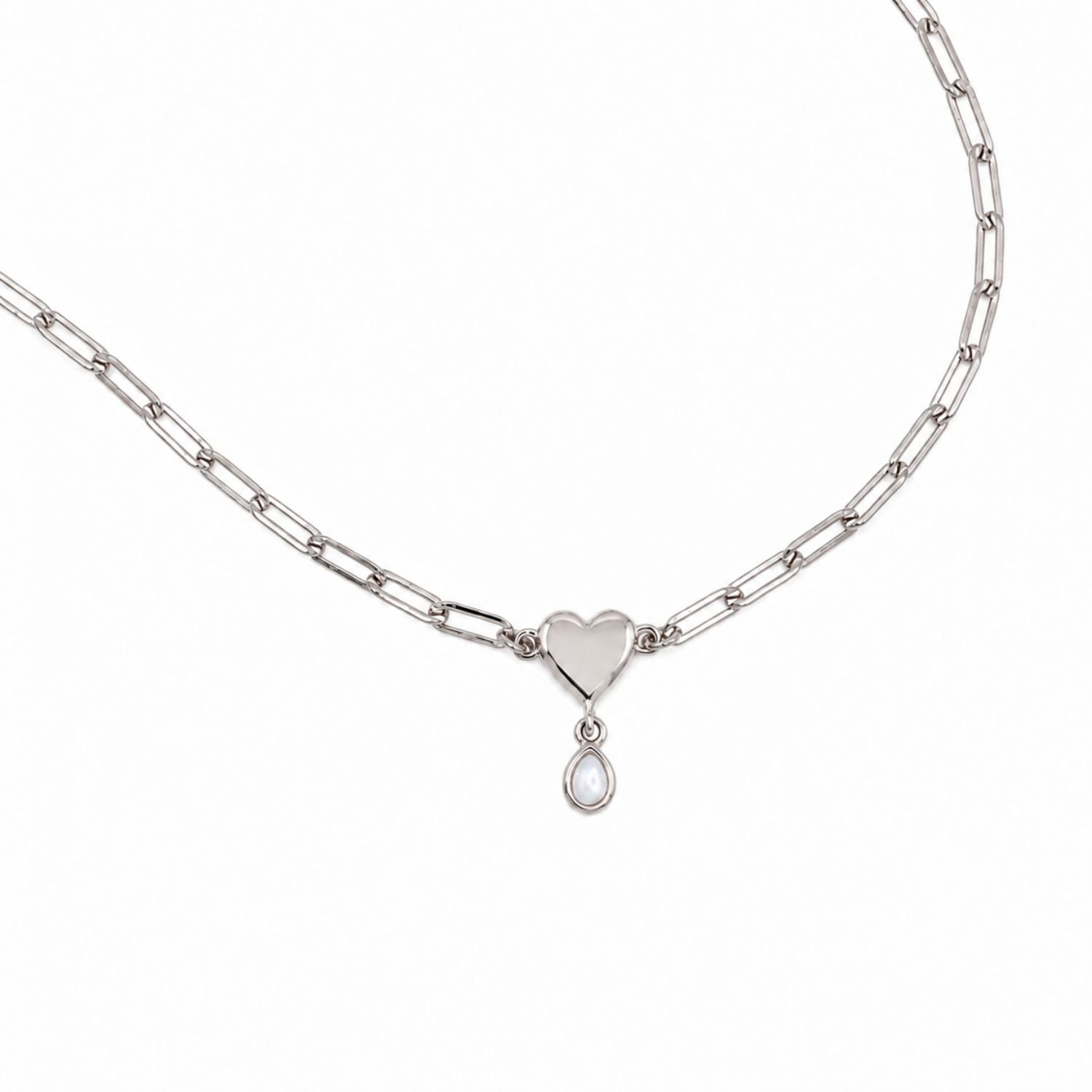 A silver paperclip chain necklace featuring a polished heart-shaped pendant with a small teardrop pearl charm below it, displayed on a clean white background.