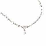 A silver paperclip chain necklace featuring a polished heart-shaped pendant with a small teardrop pearl charm below it, displayed on a clean white background.