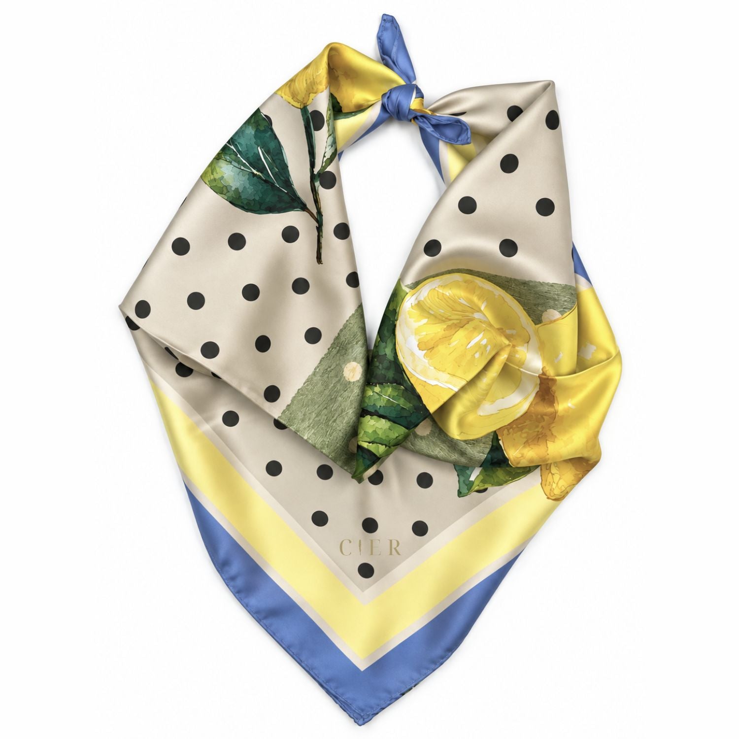 A square silk scarf with a tie-neck design, featuring a yellow lemon and green leaf pattern, black polka dots on a beige background, and blue and yellow striped borders. A small 'CIER' gold logo near the corner.