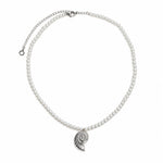 A pearl necklace with a silver spiral shell pendant, displayed on a clean white background.