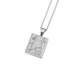 A silver rectangular pendant necklace featuring an astrological design with a small light blue gemstone and Roman numeral XII, suspended from a silver chain on a white background.