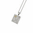 A silver pendant necklace featuring a rectangular shape, engraved details, a textured floral motif, and small clear gemstones, suspended from a delicate gold chain on a white background.