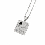A silver-toned necklace featuring a square pendant with the Roman numeral VIII, astrological symbols, and a small black diamond accent on a white background.