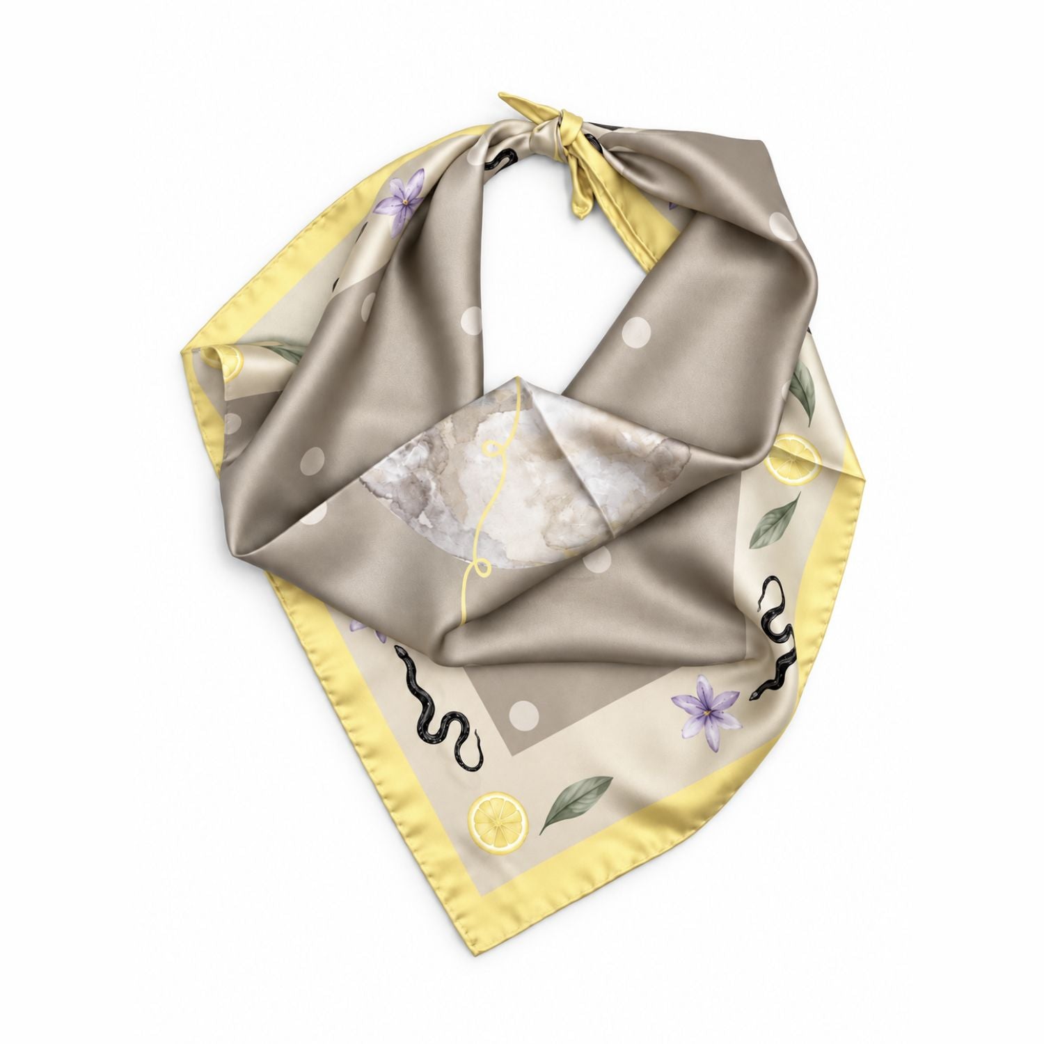 A square silk scarf with a beige and yellow base, featuring a watercolor marble pattern, small purple flowers, green leaves, and black wavy lines, tied in a loop on a white background.