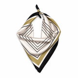 A square silk scarf with a geometric pattern of black lines, black and gold stripes, and a white border, tied in a loop at the top on a white background.