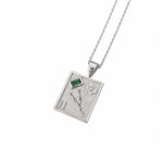 A silver-toned rectangular pendant necklace featuring a textured background with a small green rectangular gemstone, a flower motif, and the Roman numeral II, suspended from a fine silver chain against a white background.