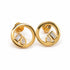 A pair of gold circular stud earrings with baguette and pear-cut lab-grown diamonds, shown on a clean white background.