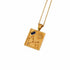 A gold pendant necklace featuring a square celestial design with a constellation, flower motif, and a small dark blue rectangular inset, shown on a white background.