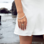 This sophisticated sterling silver bangle from our Cyclical collection is the perfect way to add a timeless flair to any look. Its classic design features a timeless silhouette that pairs effortlessly with a variety of styles. Wear with the cyclical thick or thin ring to complete the look. 