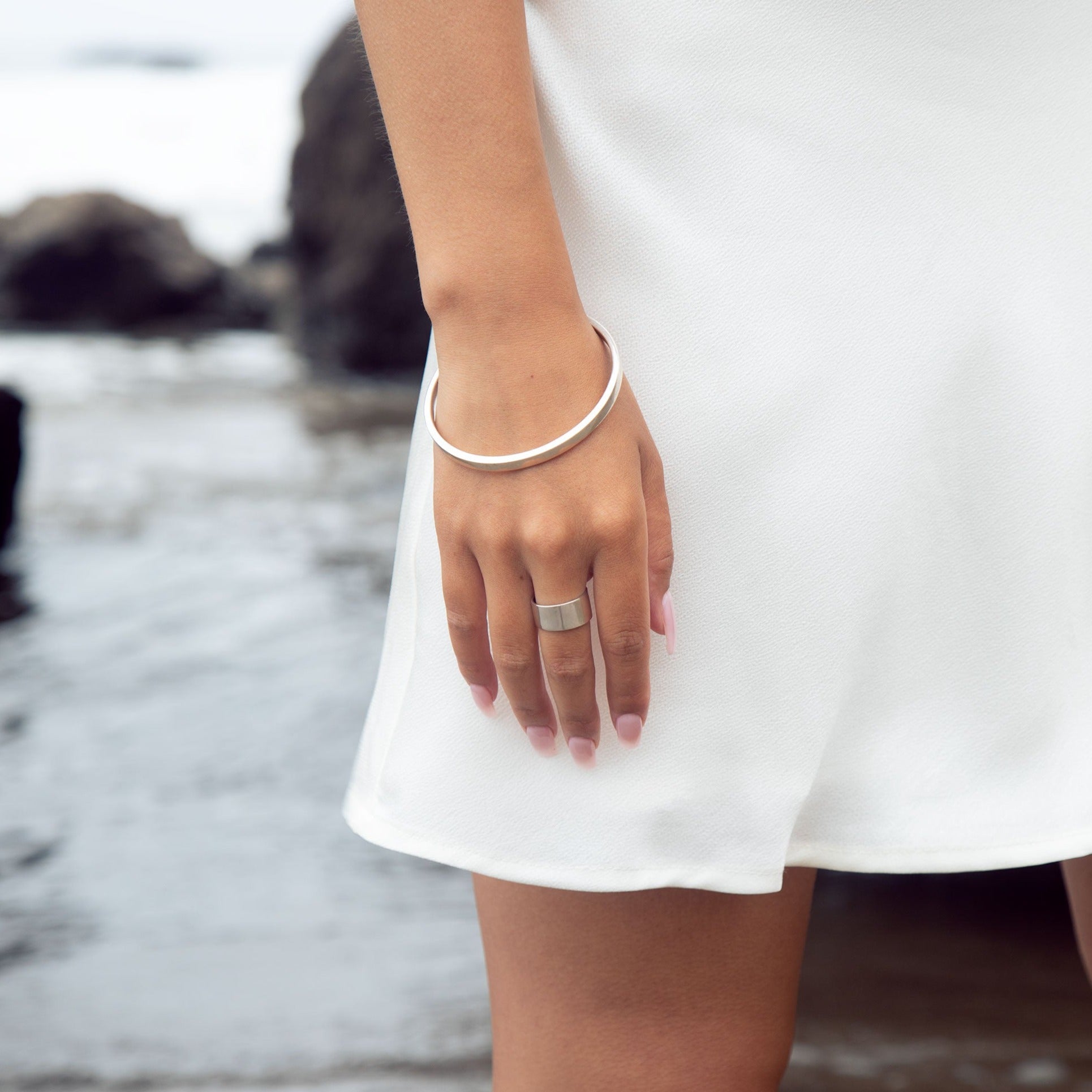 This sophisticated sterling silver bangle from our Cyclical collection is the perfect way to add a timeless flair to any look. Its classic design features a timeless silhouette that pairs effortlessly with a variety of styles. Wear with the cyclical thick or thin ring to complete the look. 