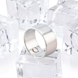 A cyclical thick ring made of sterling silver with a hexagonal center embellishment, displayed on a white background with ice cubes.