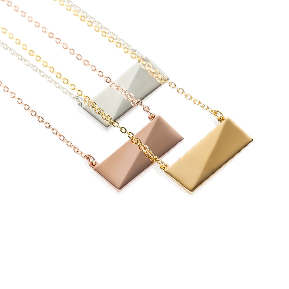 A rose gold, a gold, and sterling silver flex necklace displayed on plain white background.