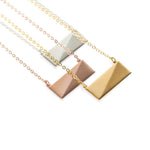 A rose gold, a gold, and sterling silver flex necklace displayed on plain white background.