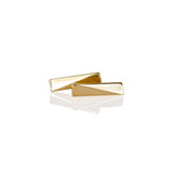 A pair of gold vermeil stud earrings on a white background with a reflection below them.