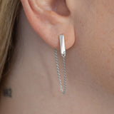 Flex falling chain earrings with lab grown diamonds close up on a model's ear. 